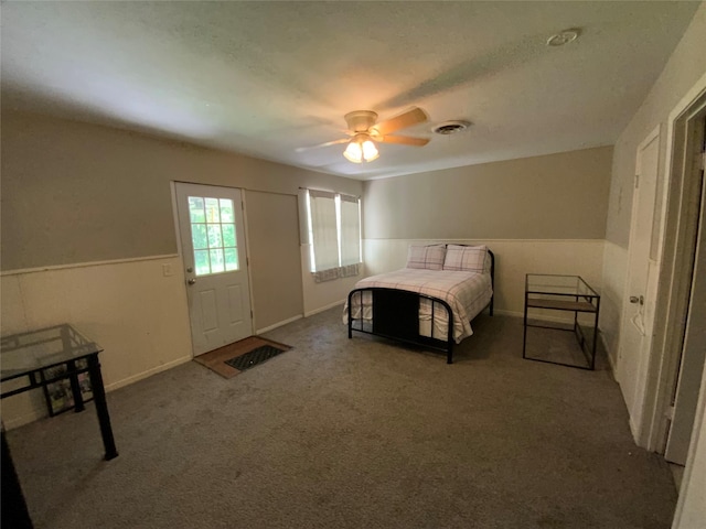 401 S Weatherford St, Chico, TX 76431 - carpeted bedroom featuring a ceiling fan and wainscoting