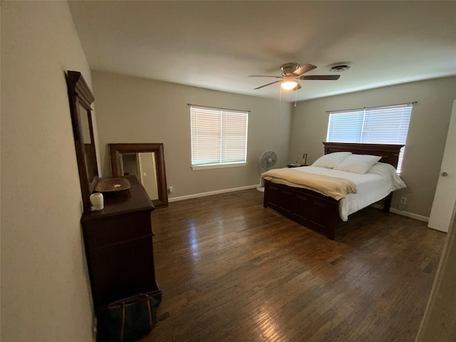 401 S Weatherford St, Chico, TX 76431 - bedroom featuring multiple windows, dark wood-style floors, and baseboards