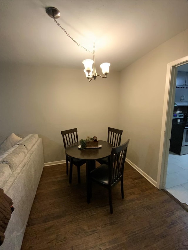 401 S Weatherford St, Chico, TX 76431 - dining room with a chandelier, baseboards, and dark wood-style flooring