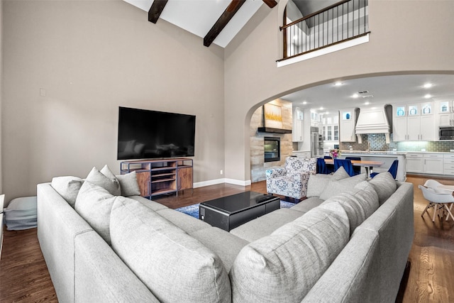 3713 Adelaide, The Colony, TX 75056 - living room featuring arched walkways, dark wood-type flooring, beam ceiling, high vaulted ceiling, and baseboards