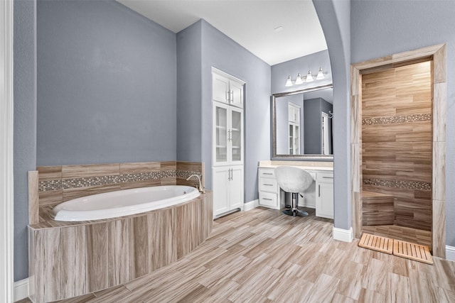 3713 Adelaide, The Colony, TX 75056 - full bath with a garden tub, vanity, tiled shower, and baseboards