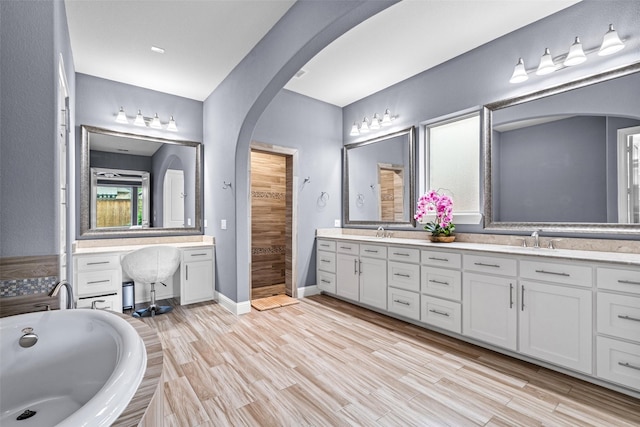 3713 Adelaide, The Colony, TX 75056 - full bath with a tub, walk in shower, wood finished floors, and double vanity