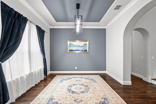 3713 Adelaide, The Colony, TX 75056 - dining room with arched walkways, dark wood finished floors, healthy amount of natural light, and a tray ceiling