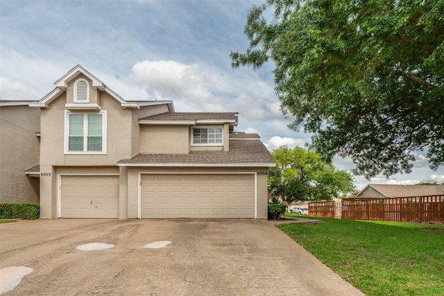 8400 Hickory St Unit 4004, Frisco, TX 75034 - view of front of property featuring stucco siding, driveway, an attached garage, and roof with shingles