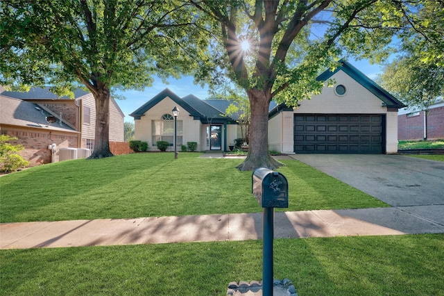 view of front of home featuring a front lawn, cooling unit, driveway, brick siding, and an attached garage