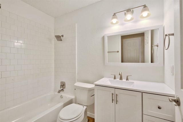 bathroom featuring toilet, shower / tub combination, and vanity