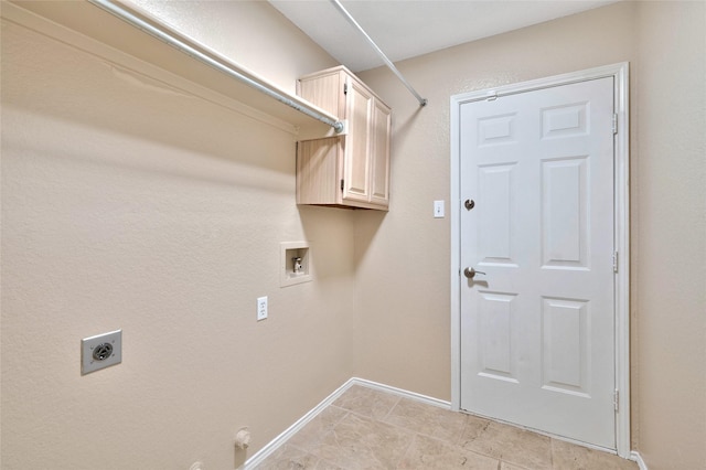 clothes washing area with hookup for an electric dryer, hookup for a washing machine, cabinet space, baseboards, and gas dryer hookup