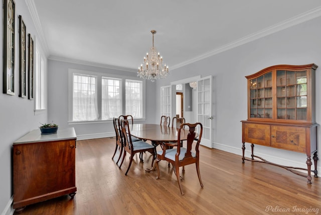 4320 Richmond Ave, Shreveport, LA 71106 - dining area featuring wood finished floors, ornamental molding, a chandelier, and baseboards