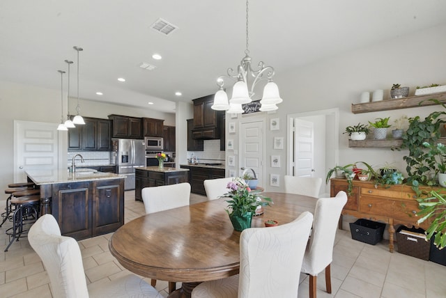 711 Red Stone Ln, Weatherford, TX 76087 - dining room featuring a chandelier, light tile patterned floors, and recessed lighting