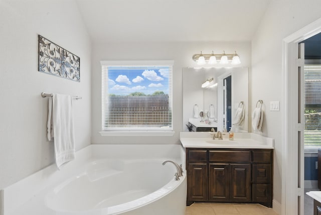 711 Red Stone Ln, Weatherford, TX 76087 - bathroom featuring a garden tub, vanity, and tile patterned floors