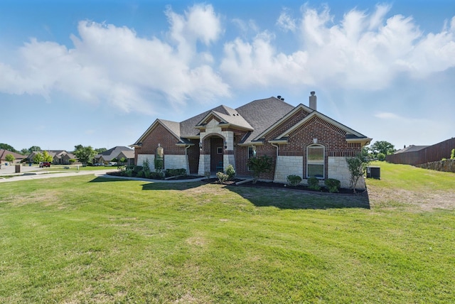 711 Red Stone Ln, Weatherford, TX 76087 - view of front of house with a chimney, stone siding, central air condition unit, and a front yard
