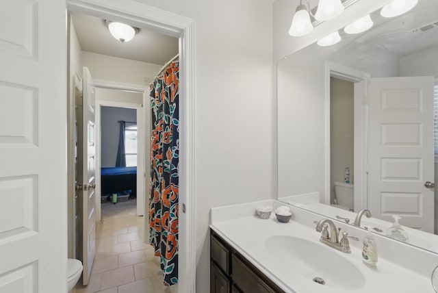 711 Red Stone Ln, Weatherford, TX 76087 - bathroom with toilet, tile patterned floors, and vanity