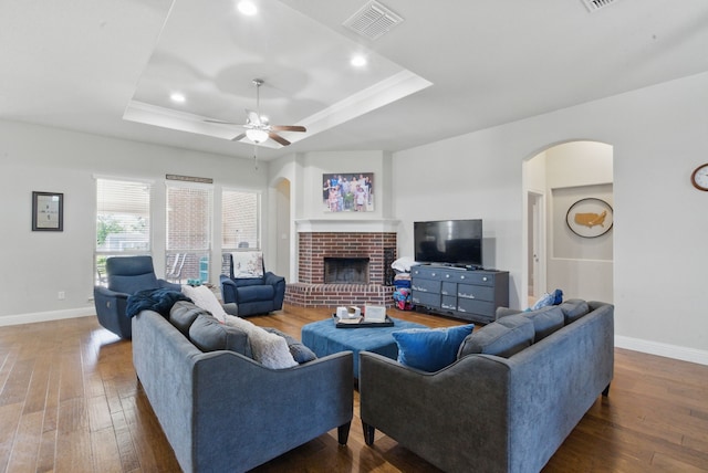 711 Red Stone Ln, Weatherford, TX 76087 - living area featuring a raised ceiling, arched walkways, hardwood / wood-style floors, baseboards, and recessed lighting