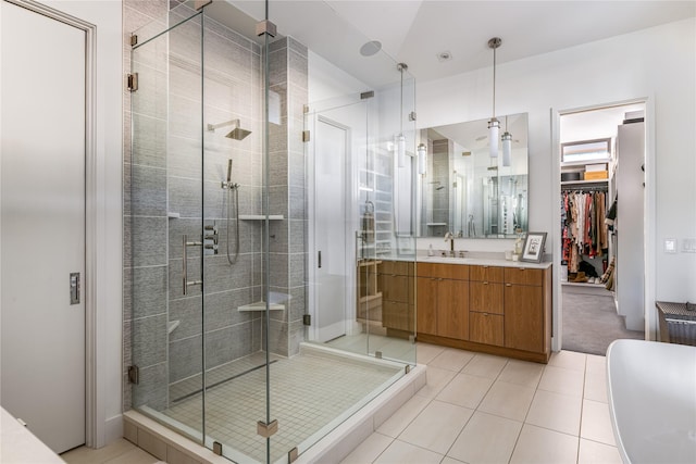 11460 Strait Ln, Dallas, TX 75229 - full bath with a shower stall, vanity, a spacious closet, and tile patterned flooring
