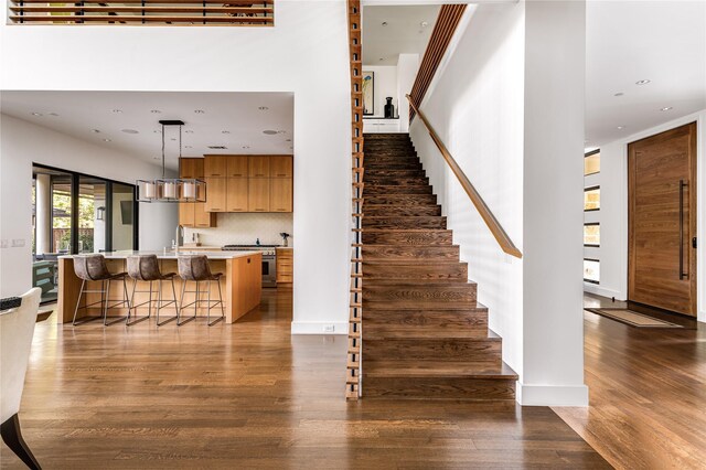 11460 Strait Ln, Dallas, TX 75229 - staircase featuring wood finished floors and recessed lighting
