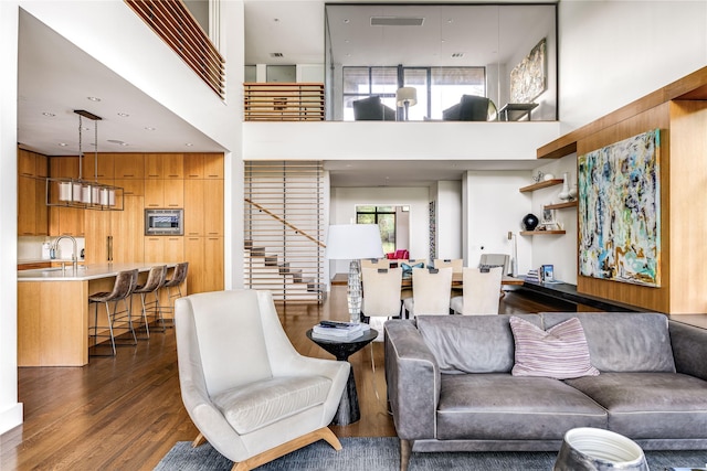 11460 Strait Ln, Dallas, TX 75229 - living room with dark wood-style floors, a high ceiling, and stairway