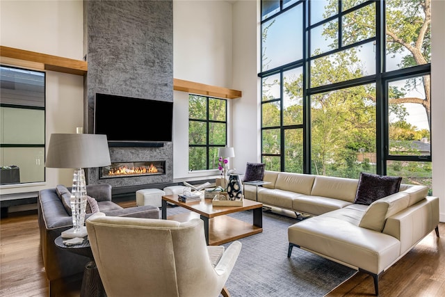 11460 Strait Ln, Dallas, TX 75229 - living room with a high ceiling, wood finished floors, and a large fireplace