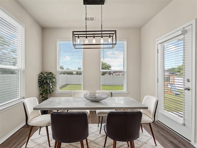 8998 Delway Dr, Providence Village, TX 76227 - dining area featuring wood finished floors, a chandelier, plenty of natural light, and baseboards