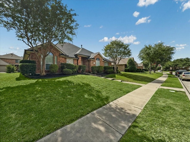 6705 Westover Dr, Rowlett, TX 75089 - view of front of property featuring brick siding, a front yard, and a shingled roof