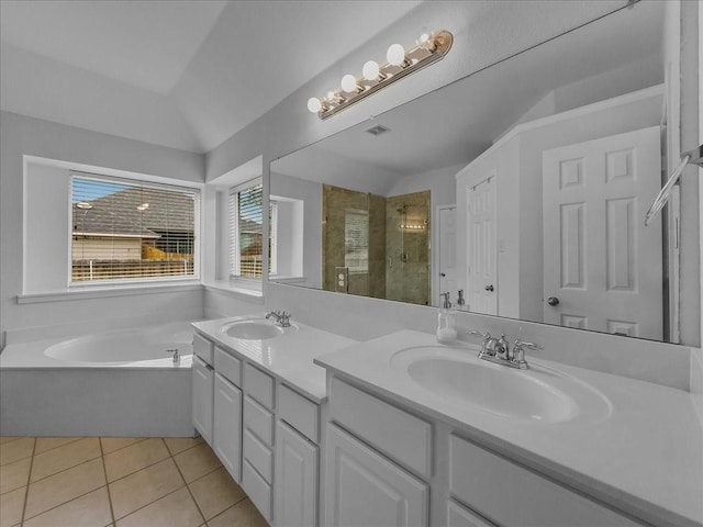 6705 Westover Dr, Rowlett, TX 75089 - bathroom featuring a stall shower, tile patterned flooring, a garden tub, double vanity, and lofted ceiling