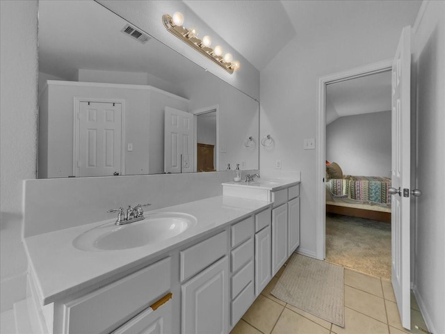 6705 Westover Dr, Rowlett, TX 75089 - ensuite bathroom with vaulted ceiling, double vanity, and tile patterned flooring