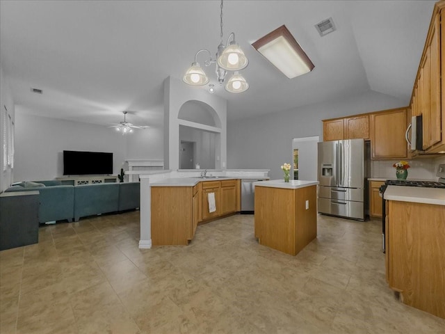 6705 Westover Dr, Rowlett, TX 75089 - kitchen featuring appliances with stainless steel finishes, ceiling fan, light countertops, a center island, and open floor plan