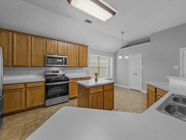 6705 Westover Dr, Rowlett, TX 75089 - kitchen with stainless steel appliances, lofted ceiling, a sink, brown cabinetry, and hanging light fixtures