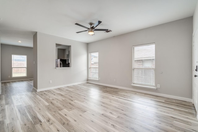 4007 Freedom St, Heartland, TX 75126 - unfurnished living room featuring a ceiling fan, light wood-style flooring, and baseboards