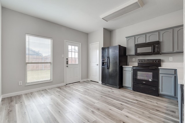 4007 Freedom St, Heartland, TX 75126 - kitchen featuring black appliances, gray cabinets, light wood-style flooring, light countertops, and baseboards