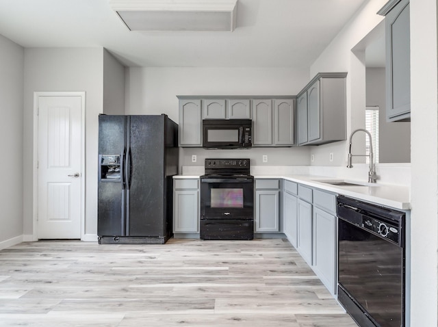 4007 Freedom St, Heartland, TX 75126 - kitchen with black appliances, gray cabinetry, a sink, and light countertops