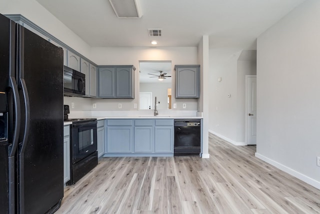 4007 Freedom St, Heartland, TX 75126 - kitchen featuring black appliances, a sink, light wood finished floors, and light countertops