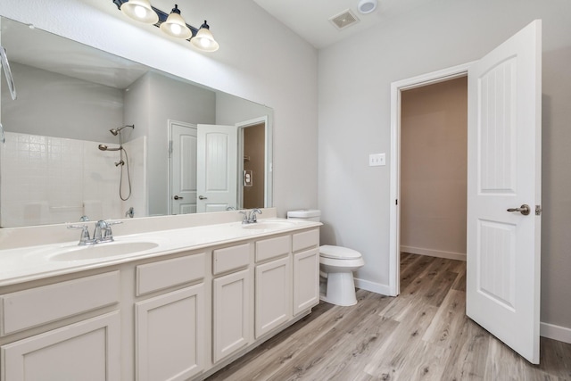 4007 Freedom St, Heartland, TX 75126 - full bath with a shower, wood finished floors, double vanity, baseboards, and toilet