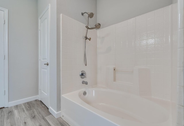 4007 Freedom St, Heartland, TX 75126 - full bath featuring wood finished floors, tub / shower combination, and baseboards