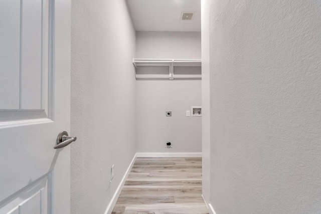 4007 Freedom St, Heartland, TX 75126 - laundry area with hookup for an electric dryer, hookup for a washing machine, light wood-style flooring, a textured wall, and baseboards