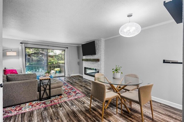 4571 N O Connor Rd Unit 1323, Irving, TX 75062 - dining area with ornamental molding, wood finished floors, baseboards, a fireplace, and a textured ceiling