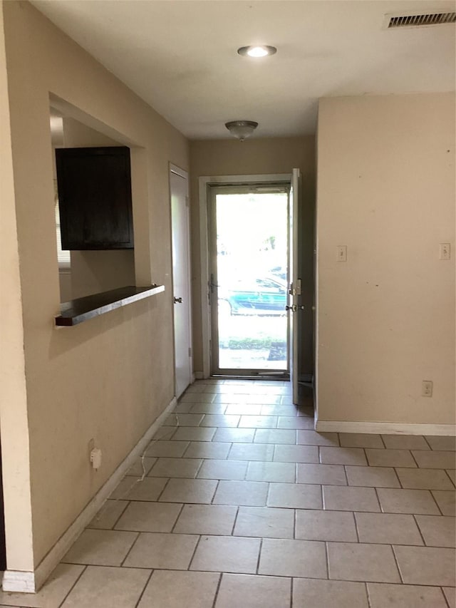 6341 Leaning Oak St, Dallas, TX 75241 - doorway featuring baseboards, light tile patterned flooring, and recessed lighting