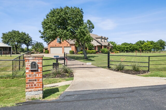 3060 Anna Cade Cir, Rockwall, TX 75087 - view of property hidden behind natural elements with a gate and concrete driveway
