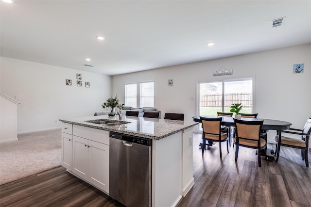 2115 Revere Dr, Princeton, TX 75407 - kitchen with stainless steel dishwasher, a sink, dark wood-style flooring, light stone counters, and a center island with sink