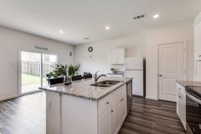 2115 Revere Dr, Princeton, TX 75407 - kitchen featuring appliances with stainless steel finishes, a sink, dark wood-type flooring, white cabinets, and recessed lighting