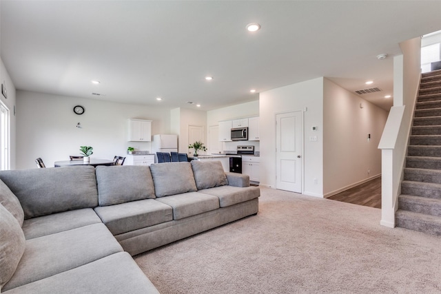 2115 Revere Dr, Princeton, TX 75407 - living area featuring stairway, light carpet, recessed lighting, and baseboards