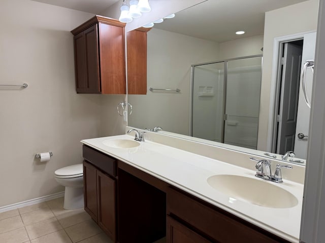 7421 Kite Ln, Frisco, TX 75036 - bathroom with baseboards, toilet, a stall shower, double vanity, and tile patterned floors