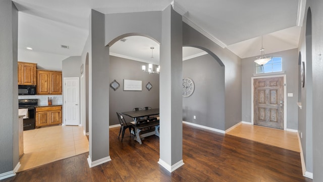 109 Harvest Way, Crandall, TX 75114 - entryway with arched walkways, baseboards, wood finished floors, crown molding, and lofted ceiling