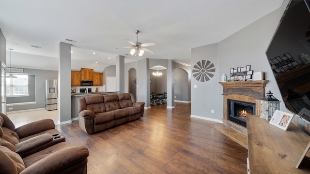 109 Harvest Way, Crandall, TX 75114 - living room with arched walkways, wood finished floors, lofted ceiling, ceiling fan, and baseboards