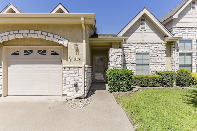 819 Earhart Ave, Grand Prairie, TX 75051 - view of front of house featuring stone siding, a garage, driveway, and a front yard