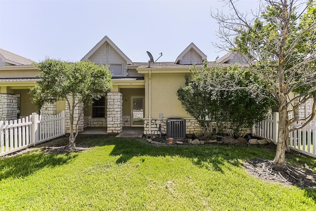 819 Earhart Ave, Grand Prairie, TX 75051 - rear view of house with central air condition unit, stucco siding, and stone siding