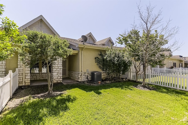 819 Earhart Ave, Grand Prairie, TX 75051 - view of side of home featuring central AC, stone siding, stucco siding, and a shingled roof