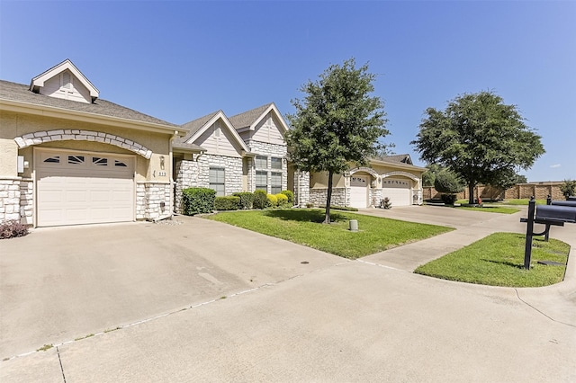 819 Earhart Ave, Grand Prairie, TX 75051 - view of front of property with driveway, an attached garage, stone siding, and a front lawn