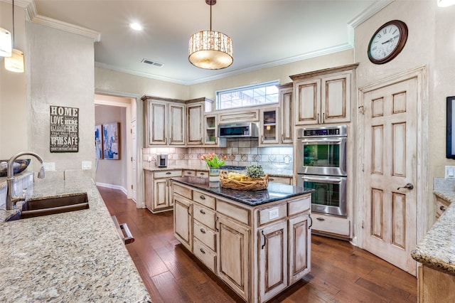 4 Rushing Meadow Ct, Dalworthington Gardens, TX 76016 - kitchen featuring stainless steel appliances, a sink, light stone counters, dark wood finished floors, and crown molding