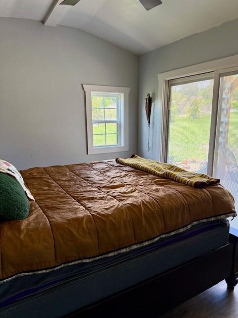 7700 County Road 144, Stephenville, TX 76401 - bedroom with vaulted ceiling, wood finished floors, and access to outside