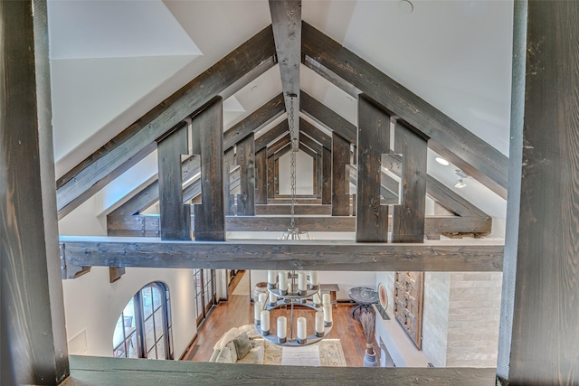 detailed view of a chandelier and beam ceiling